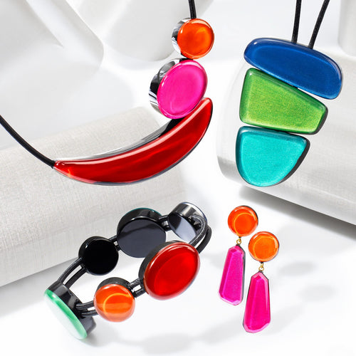 Libra collection — Three glossy forms — a half-moon, a wedge and a rounded triangle — stacked into a single pendant, each colourway on its own cord.