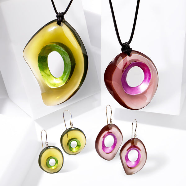 Crescence collection — Hollow sculptural forms with a metallic core and a translucent outer shell, drawn from the light of Murano glass.