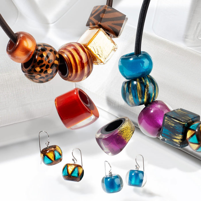 Glam Series collection — Translucent champagne, silver and copper beside solid metallic rings and spacers, with pearl, anthracite, wine and teal rounds.
