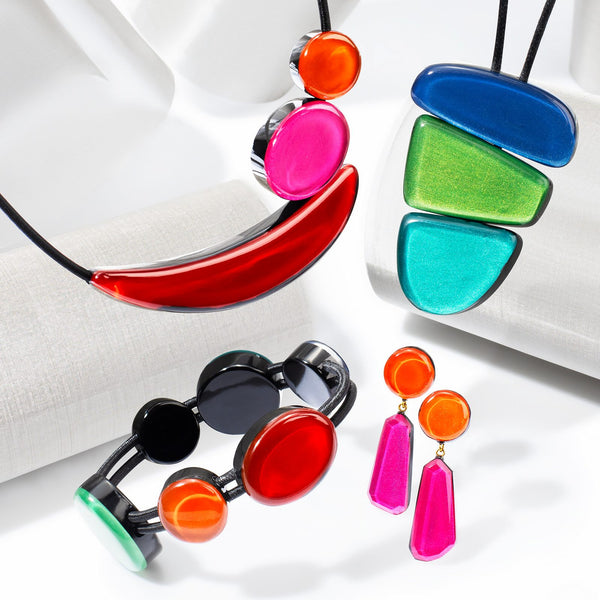 Libra collection — Three glossy forms — a half-moon, a wedge and a rounded triangle — stacked into a single pendant, each colourway on its own cord.
